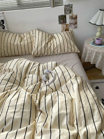 Bed with striped bedding in a bedroom setting