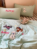 Children's bedding set with puppy-themed design on a bed.