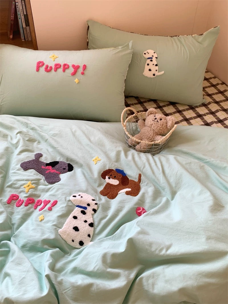 Children's bedding set with puppy-themed design on a bed.