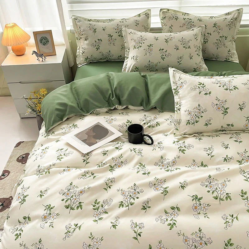 Floral bedding set on a bed with a nightstand and lamp in the background.