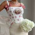 Pink coquette corset with lace and bow details for vintage-inspired outfits