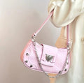 Pink handbag with edgy heart-shaped charm