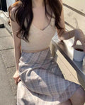 Elegant plaid skirt worn with crop top and leather jacket