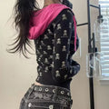 Model wearing Y2K skeleton zip-up with pink drawstring hood.
