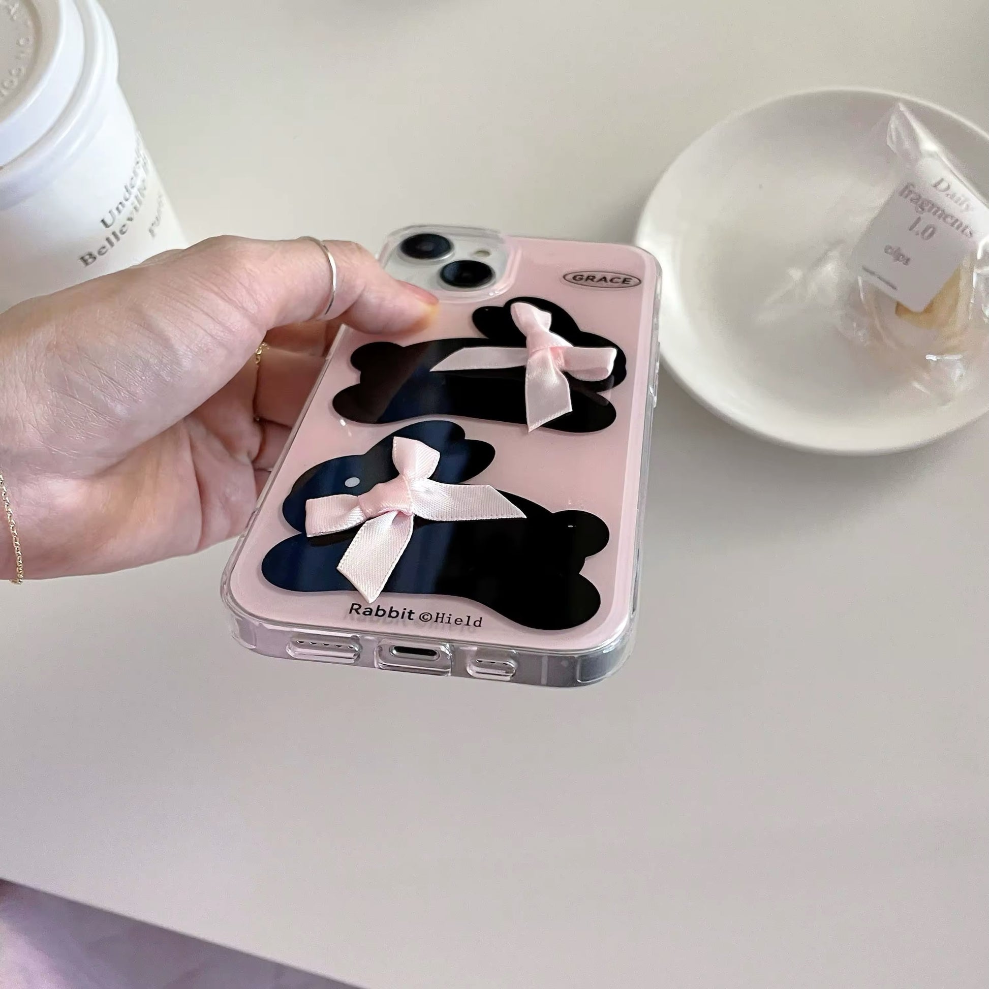 Cute pink rabbit phone cover with stylish bow detail for iPhone models