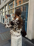 Trendy cow print jacket with soft wool texture, turn-down collar and short cut for modern vintage street style