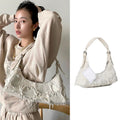 Soft girl baguette shoulder bag with tassel details and canvas fabric in neutral tones for aesthetic outfits