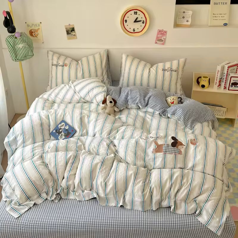 Striped bedding set with cartoon characters on a bed in a room.