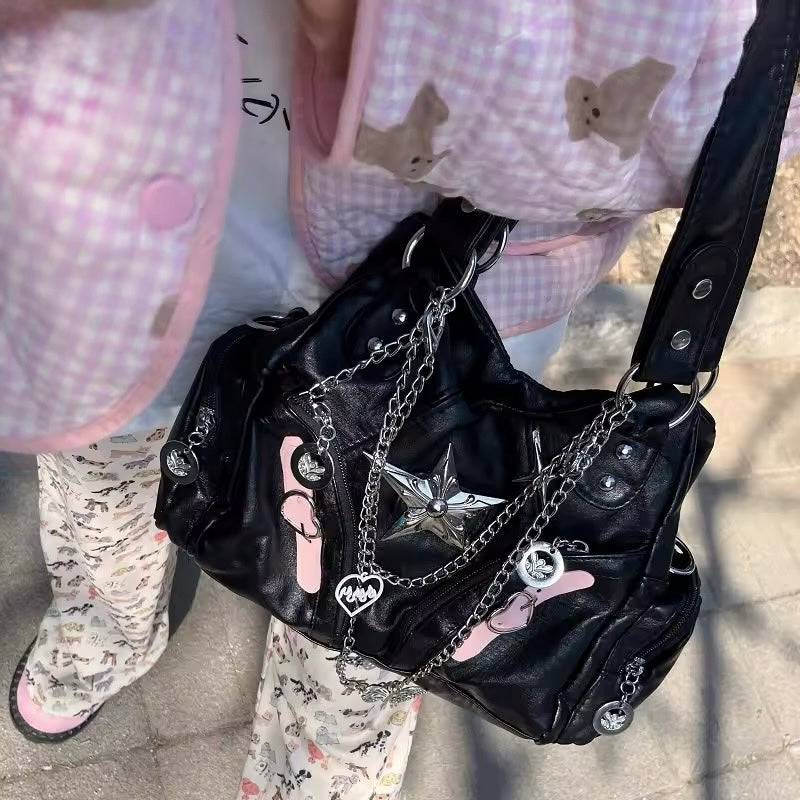 Edgy black leather tote with chunky silver chain straps
