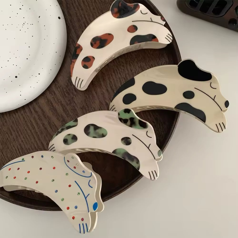 Close-up of the spotted dog acetate hair claw clip showcasing its intricate rhinestone embellishments and glossy finish
