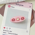 Top view of red apple fruit hair clips arranged neatly on a decorative dish, showing off glossy finish