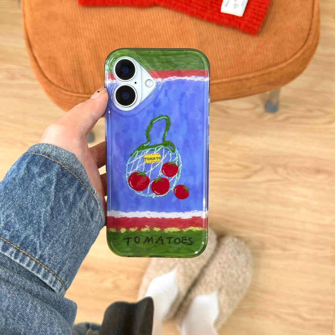 Back view displaying the detailed tomato artwork and secure fit on iPhone
