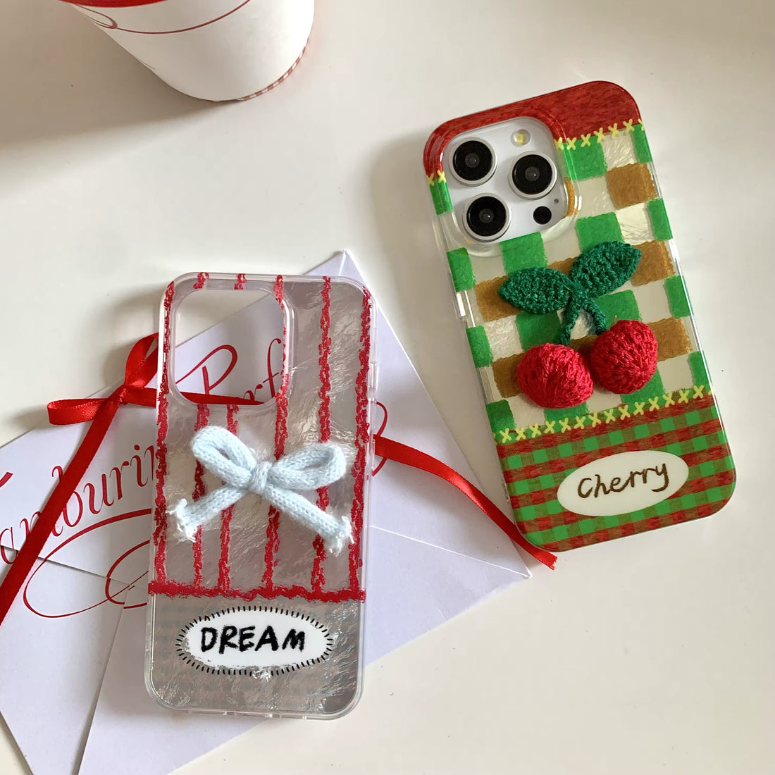 The iPhone case placed next to a balletcore-themed notebook and pen