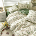 Floral bedding set on a bed with matching pillows in a bedroom setting.