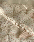Floral patterned comforter with ruffled edges on a bed