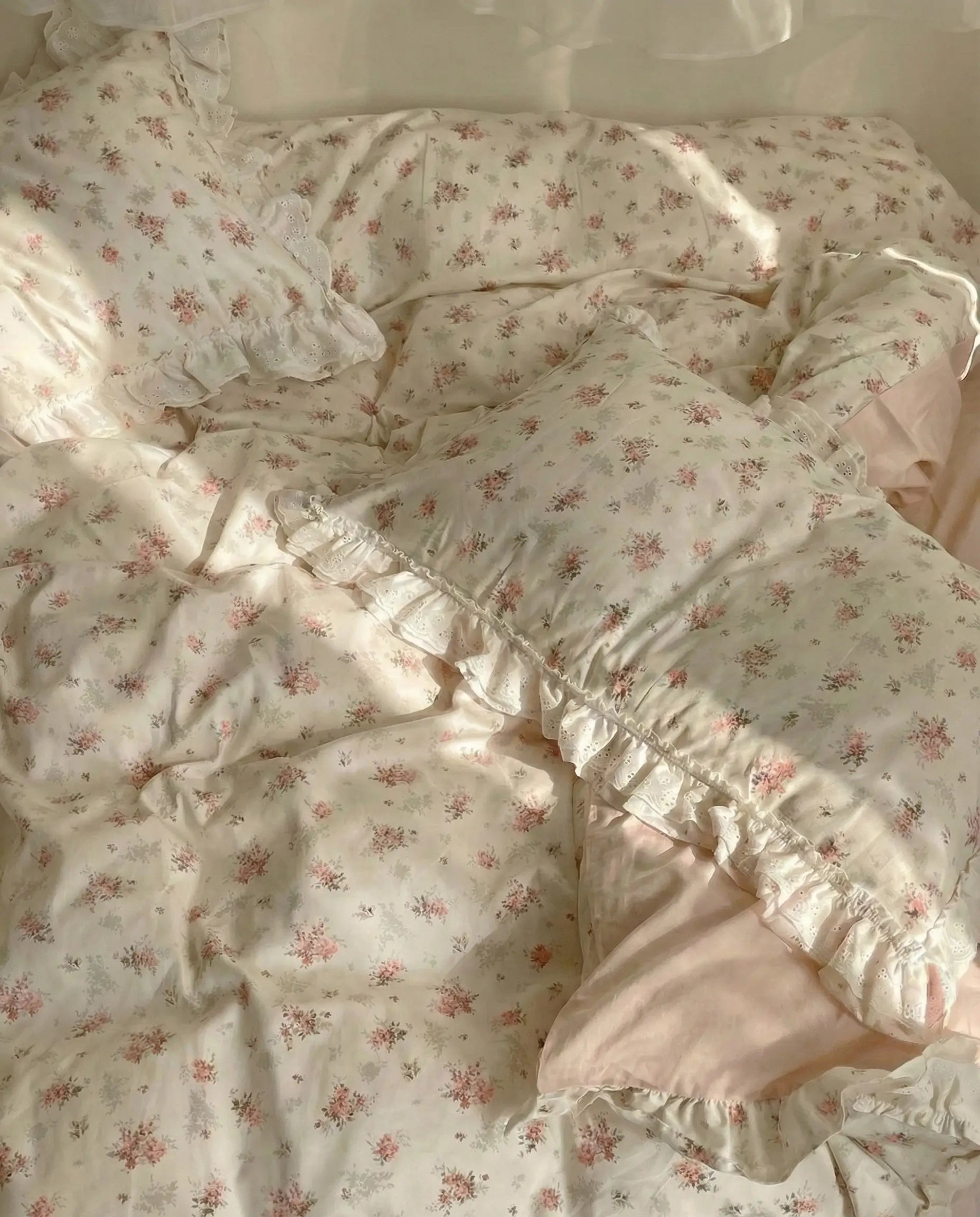 Floral patterned comforter with ruffled edges on a bed