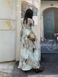 Vintage Y2K-inspired maxi dress with flared sleeves and boho-chic vibe