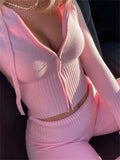 Woman posing in pink Y2K tracksuit for Instagram look