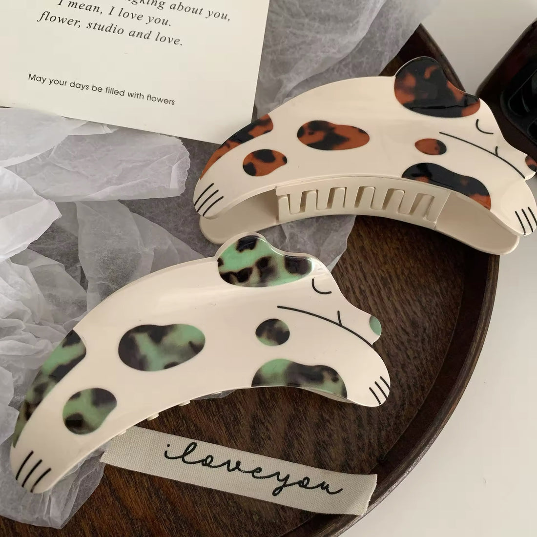 Close-up of the spotted dog acetate hair claw clip showcasing its intricate rhinestone embellishments and glossy finish