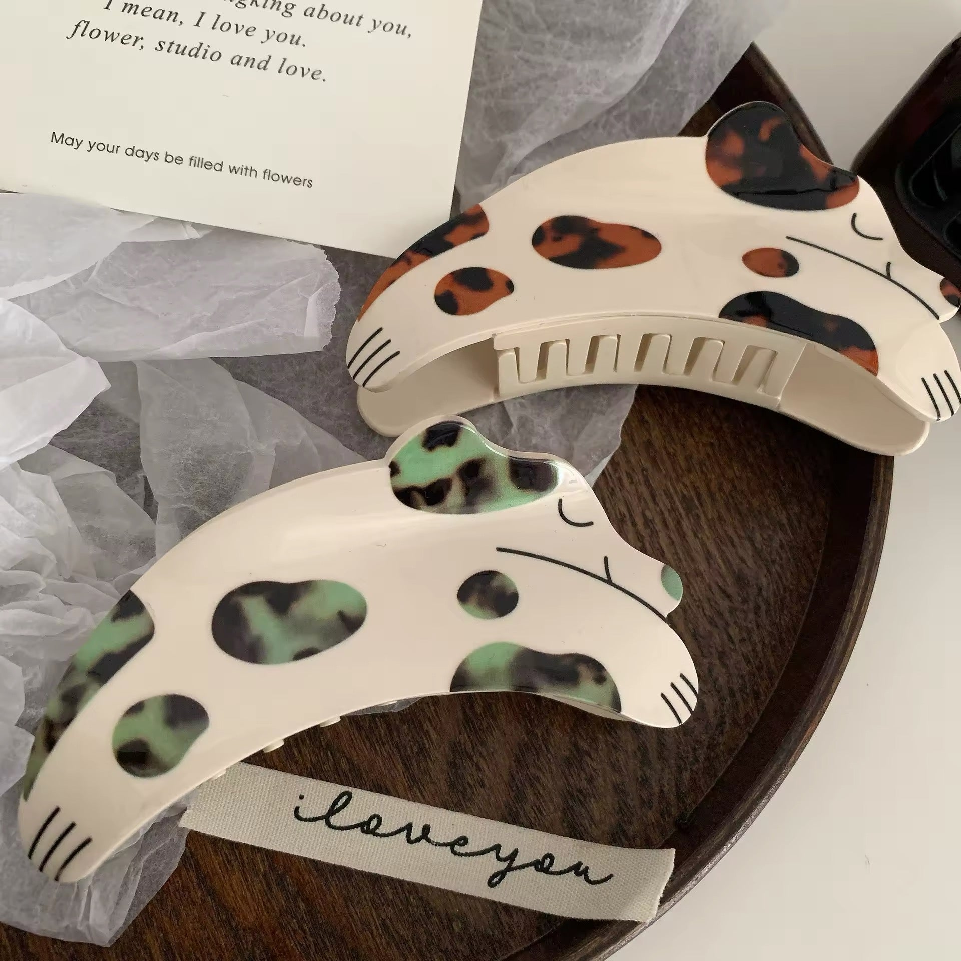 The hair clip securing a model's thick, curly hair in a stylish updo, highlighting its strong hold and design