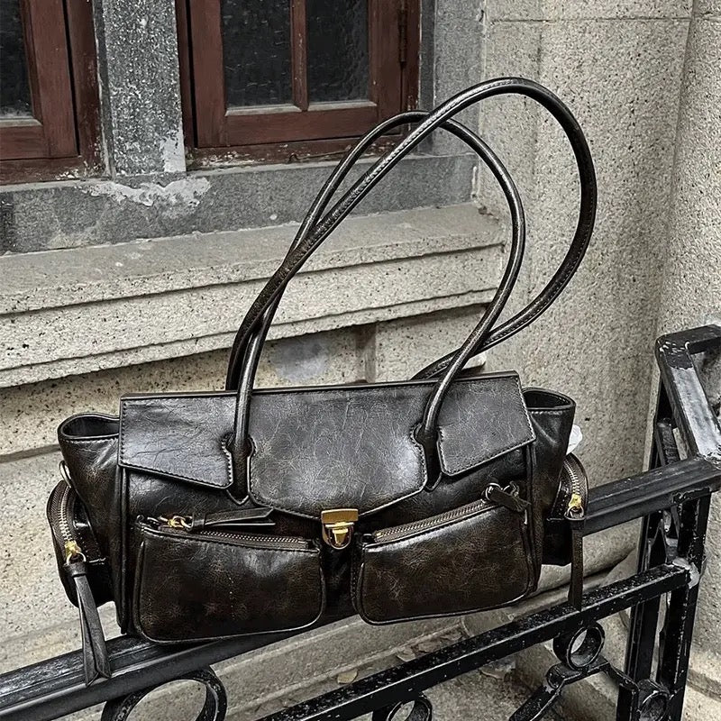 Grunge-style shoulder bag with long strap and Y2K retro vibe