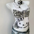Model wearing the Y2K corset cami paired with a pleated skirt, embodying college girl style