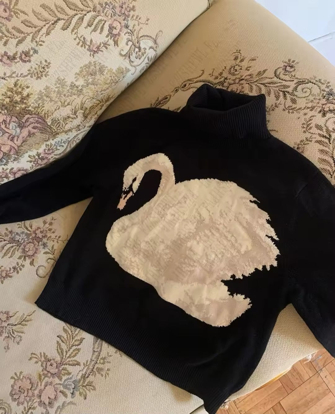 Model wearing vintage swan motif sweater in winter look