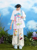 Front view of white wide leg jeans with bold colorful cartoon prints and graffiti details