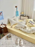 Modern bedroom with a bed, side table, and decor items.