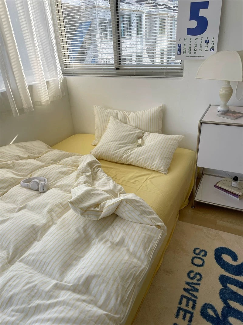 Bedroom with a bed, pillows, and a window with blinds.